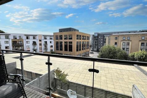 Sunny balcony view overlooking modern buildings...