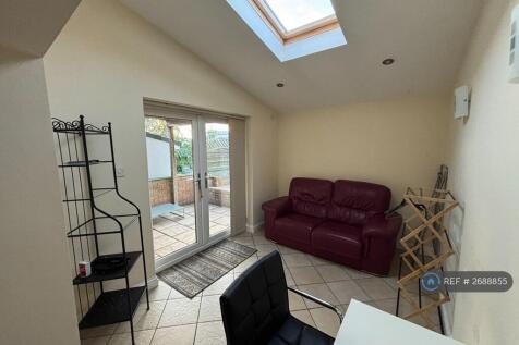 Living Area With Spare Desk And Leather Sofa 