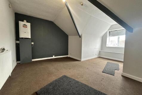 Spacious attic room with modern feature wall...