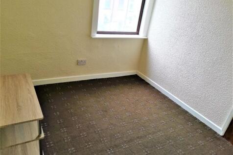 Compact furnished single bedroom with a corner ...