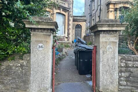 Stone entrance pillars and pathway leading up t...