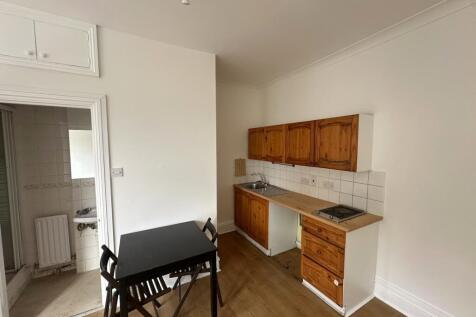 Compact kitchen with dining table and natural t...