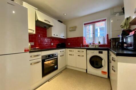 Modern kitchen with vibrant red tiling....