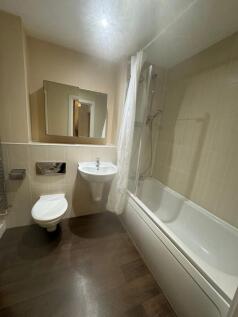 Modern bathroom with shower over bath...