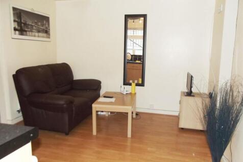Bright, simply furnished living room with wood ...