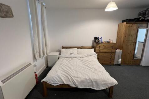 Spacious bedroom with ample wooden storage...