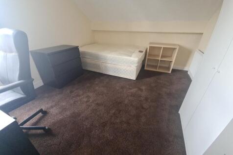 A simple, small bathroom with a toilet, showcas...