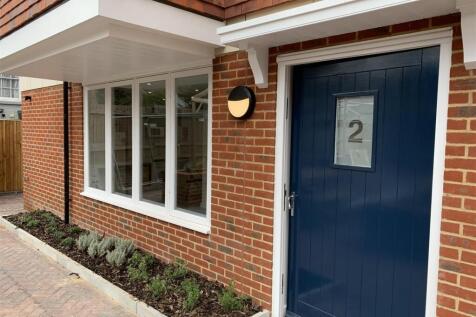 Neat modern entrance with planted border...