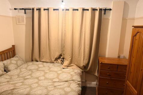 Cosy double bedroom with ample wooden storage...