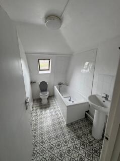 Bright bathroom with stylish patterned tiles....