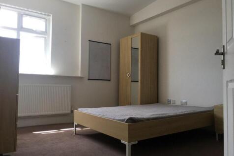 Bright, simply furnished bedroom with a window ...