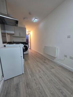 Long, modern kitchenette with wood-effect floor...