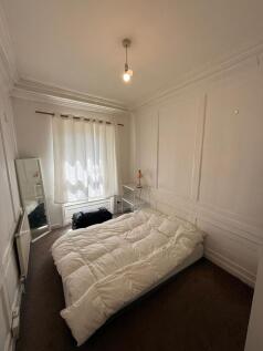 Bright double bedroom with stylish wall panelli...