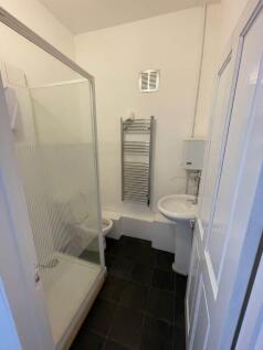 Compact bathroom with modern towel radiator...