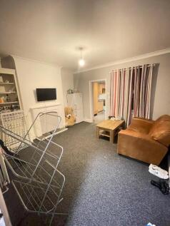 A cozy living room featuring a comfortable leat...