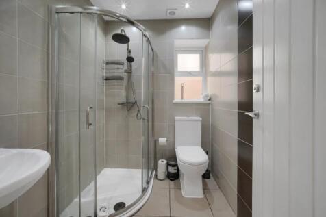 Modern tiled bathroom with sleek glass shower...