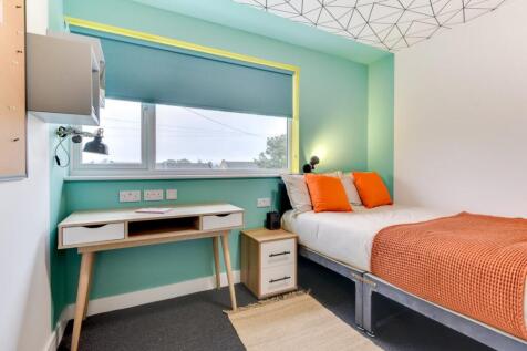 Bright modern bedroom with stylish study desk a...