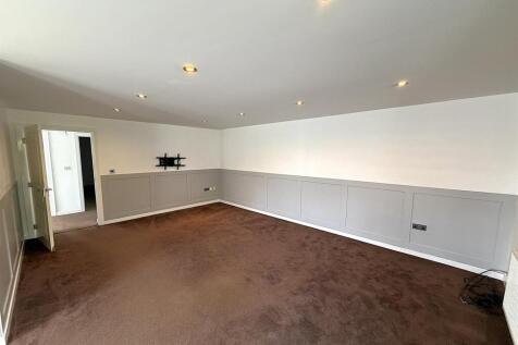 Spacious lounge with modern wall panelling....
