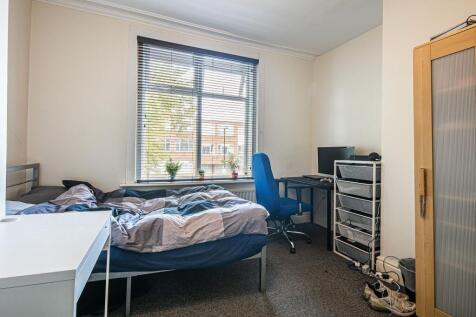 Bright, well-lit bedroom with a large window, c...