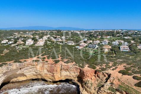 Clifftop coastal view with luxury villa at the ocean in Carvoeiro Algarve
