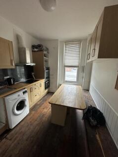 A bright and functional kitchen with ample stor...
