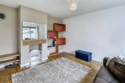 Bright lounge with wooden floors and plush rug...