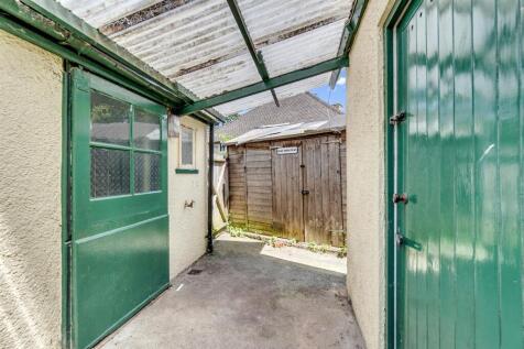 Between the house and store