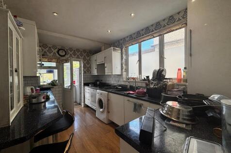 Bright kitchen with ample counter space and sea...