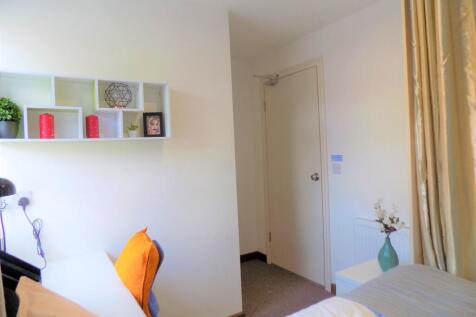 Bright, neatly presented bedroom with a cosy be...