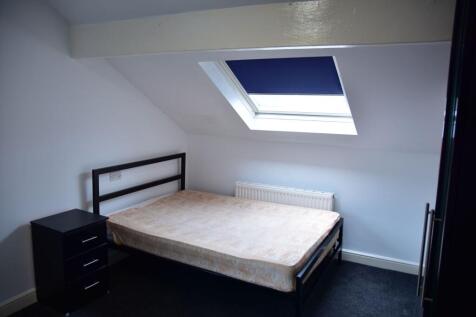 A bright and cozy bedroom featuring a skylight ...