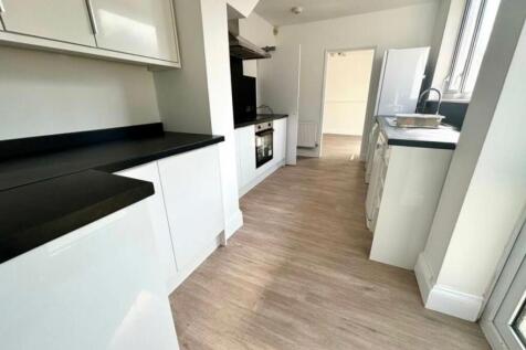 A modern and spacious kitchen with plenty of na...