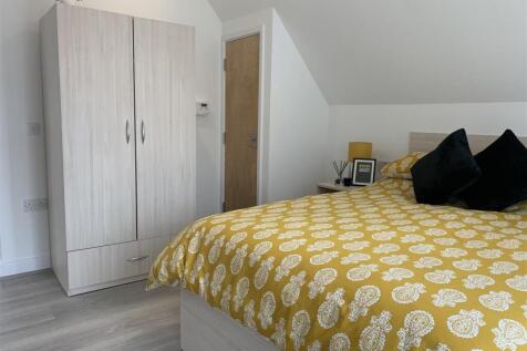 Bright modern bedroom with ample storage space...