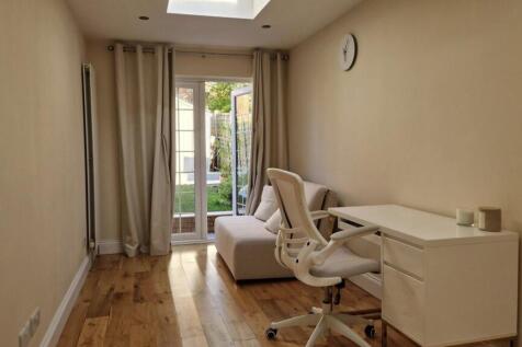 Bright study area with desk and garden access...