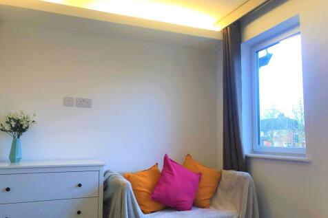 A cozy living space featuring a comfortable sof...