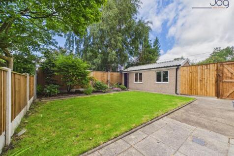 Private lawned garden with patio and mature planting