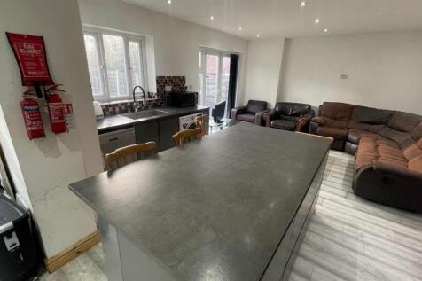 Spacious open-plan living area with a large cen...