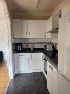 Modern fitted kitchen with integrated appliance...