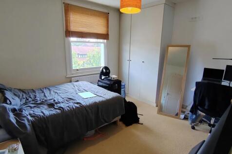 Bright bedroom with built-in storage and desk...