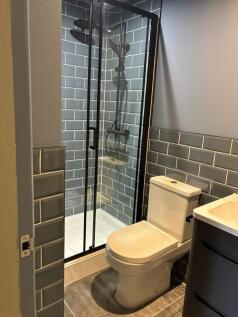 Stylish modern bathroom with rainfall shower...
