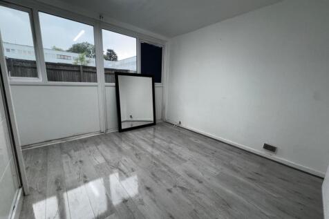 Bright modern room with sleek wood-grey wood fl...