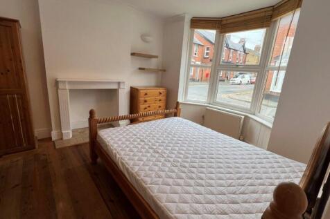 Bright spacious bedroom with charming bay windo...