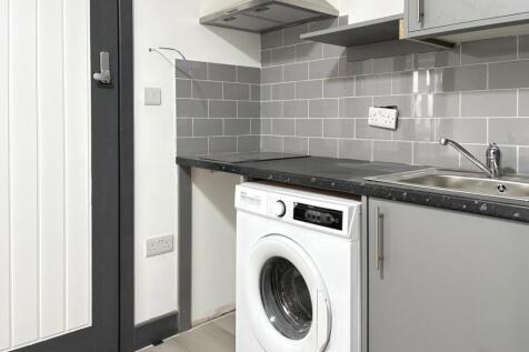 Compact, modern kitchenette featuring integrate...