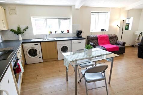 Bright open-plan kitchen and living area with a...
