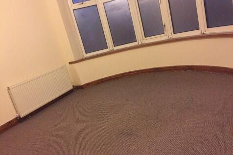 Bright corner bedroom with a bay window, neutra...