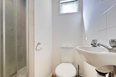 Modern bright bathroom with walk-in shower...