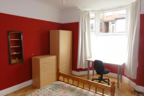 Bright and cheerful bedroom with bold red walls...