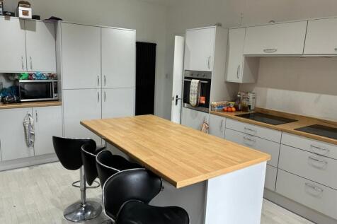 Modern kitchen with island and breakfast bar...
