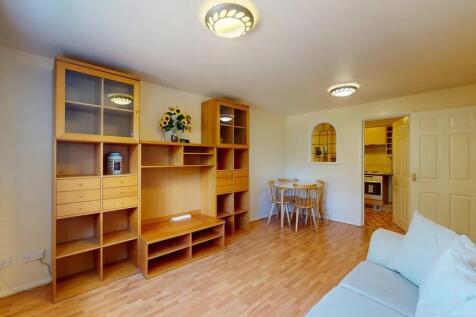 Bright, well-presented living room with warm wo...