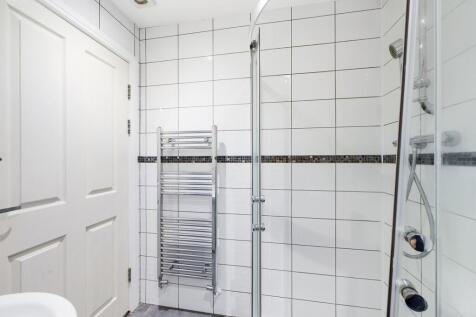 A modern and pristine bathroom featuring a spac...