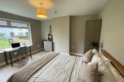 Bright and welcoming master bedroom featuring a...